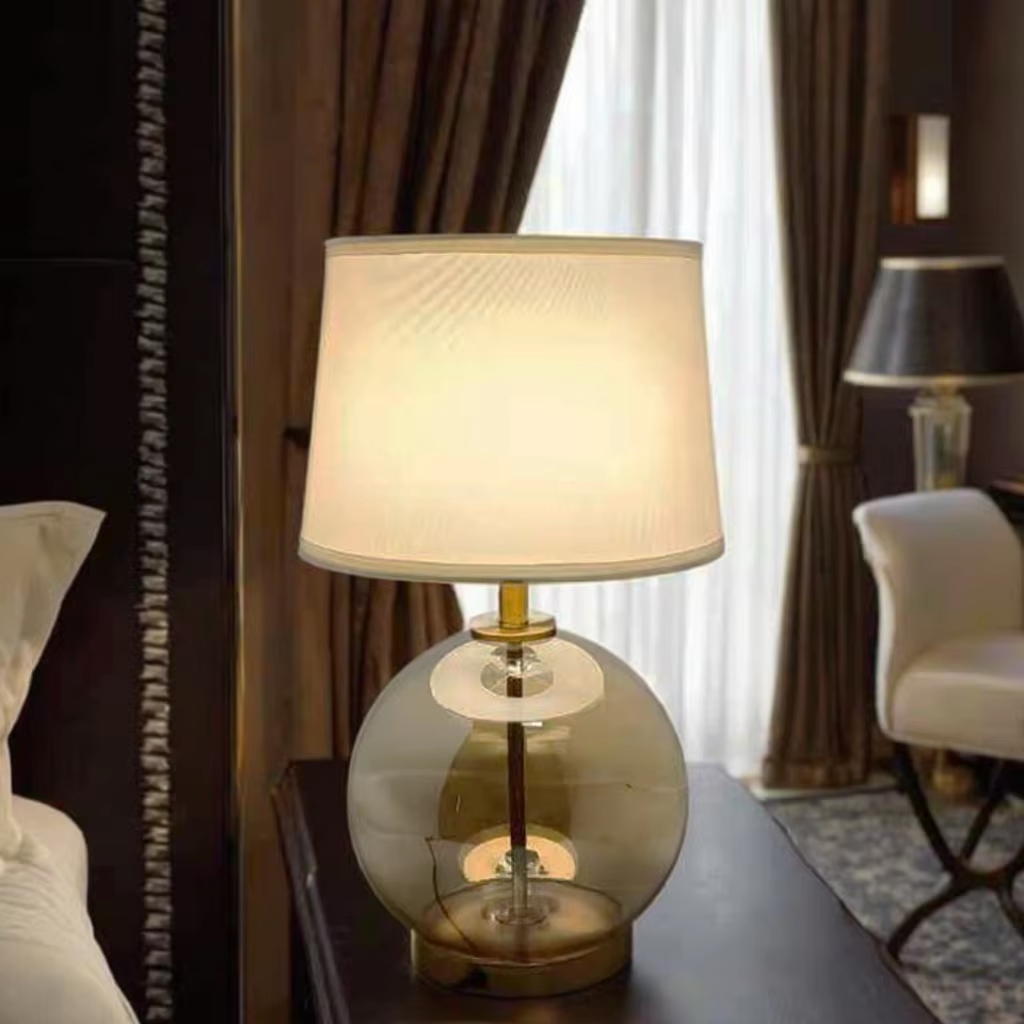 Elevate Spaces with Amber Glass Globe Table Lamp: Gold Metal Base & White Fabric Shade